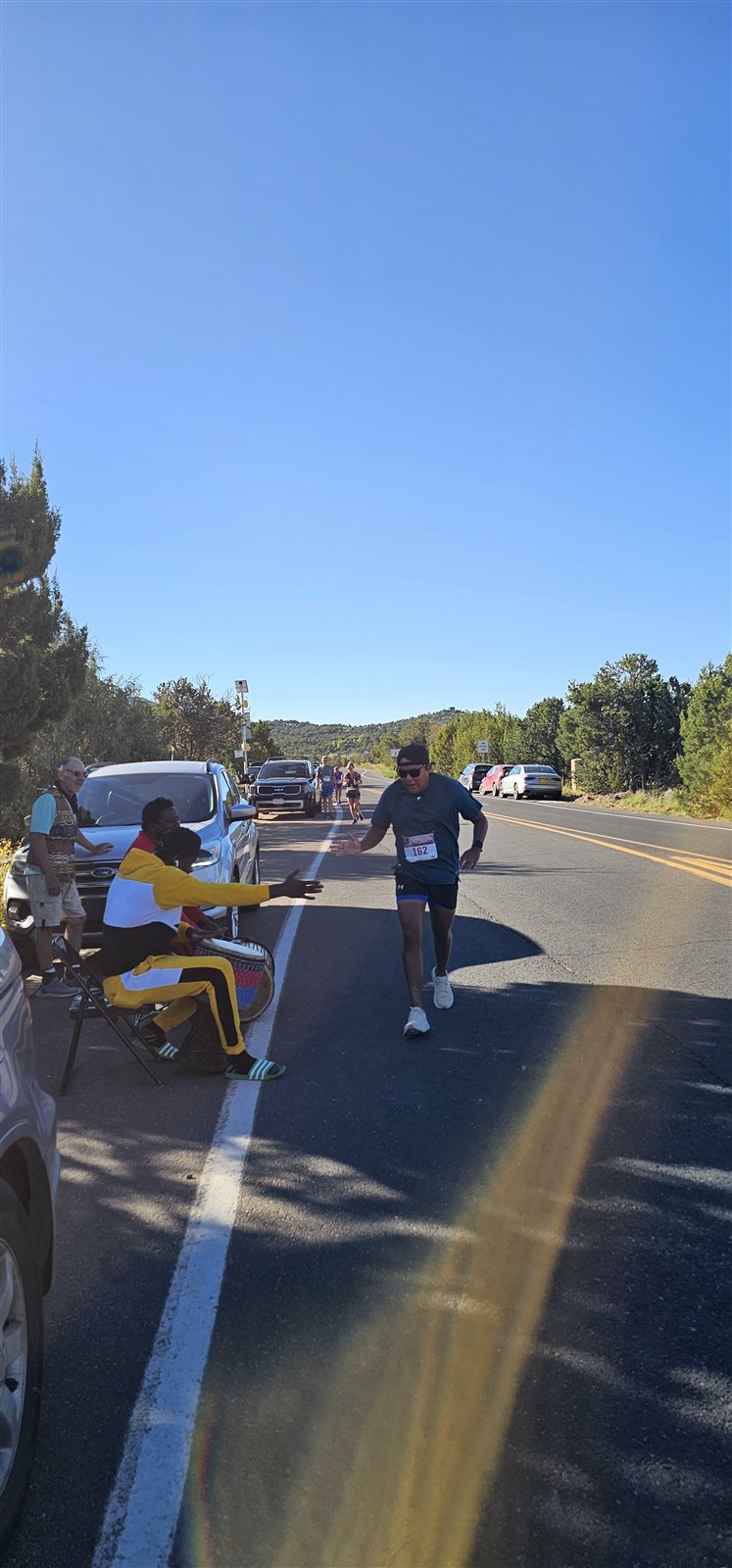 A runner greeting our traditional drummers along the high-desert course