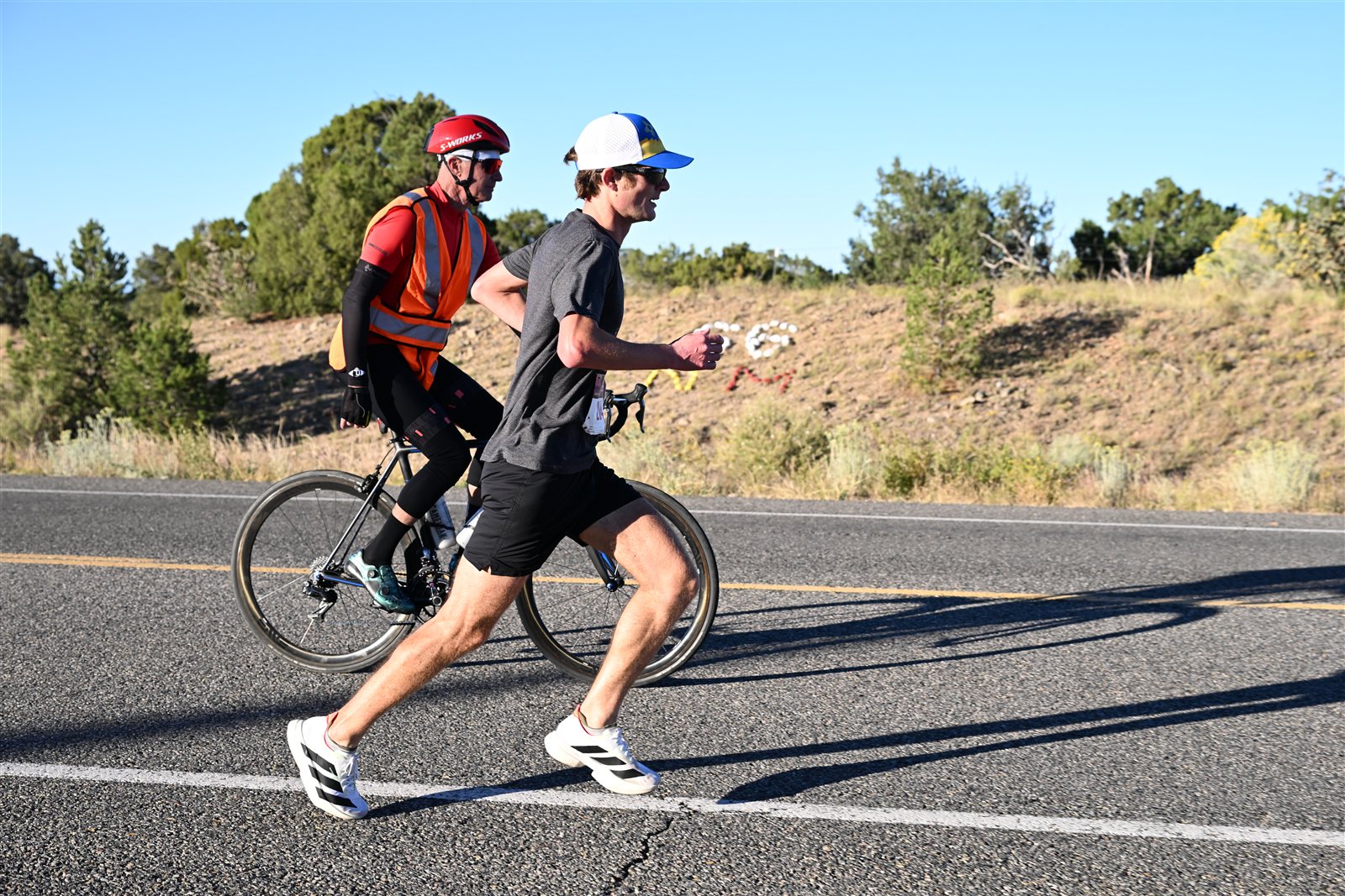 A half marathon runner paced down the high-desert road